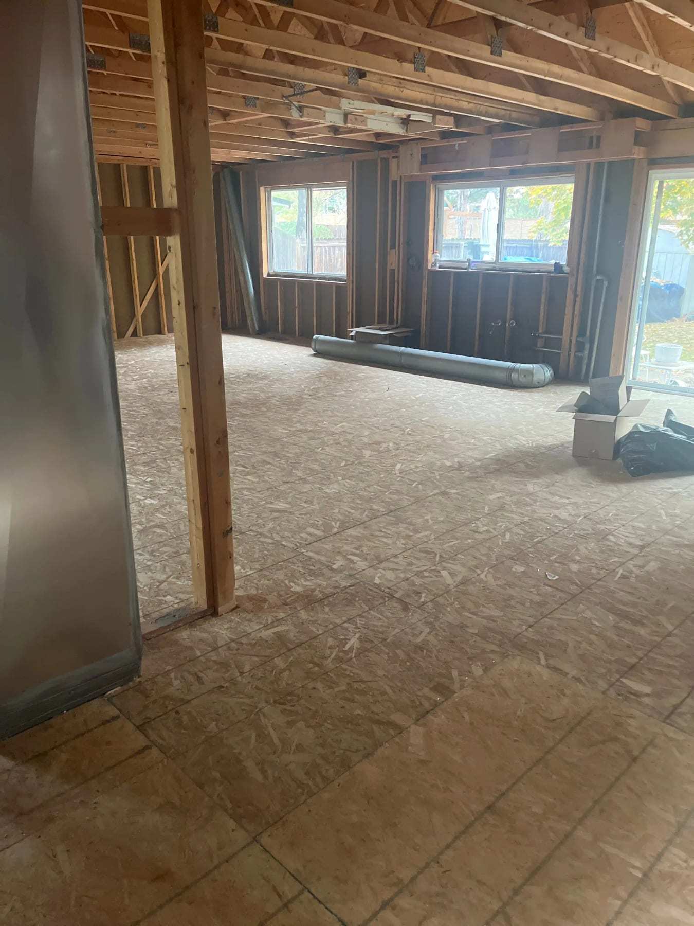 Basement stripped to the framing with a new subfloor and furnace ducting